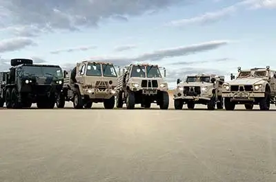 Oshkosh Defense family of military vehicles in a row.