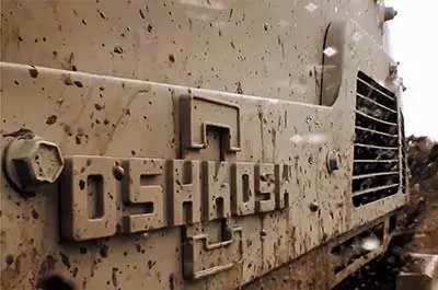 Oshkosh Defense logo on the front of a military vehicle.