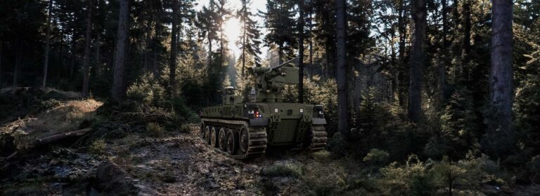 The Oshkosh Defense Robotic Combat Vehicle in a wooded environment.