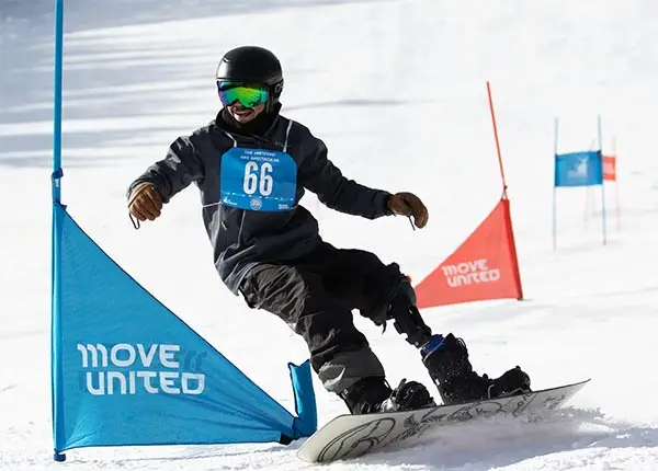 Person snowboarding at a Move United Sport event.