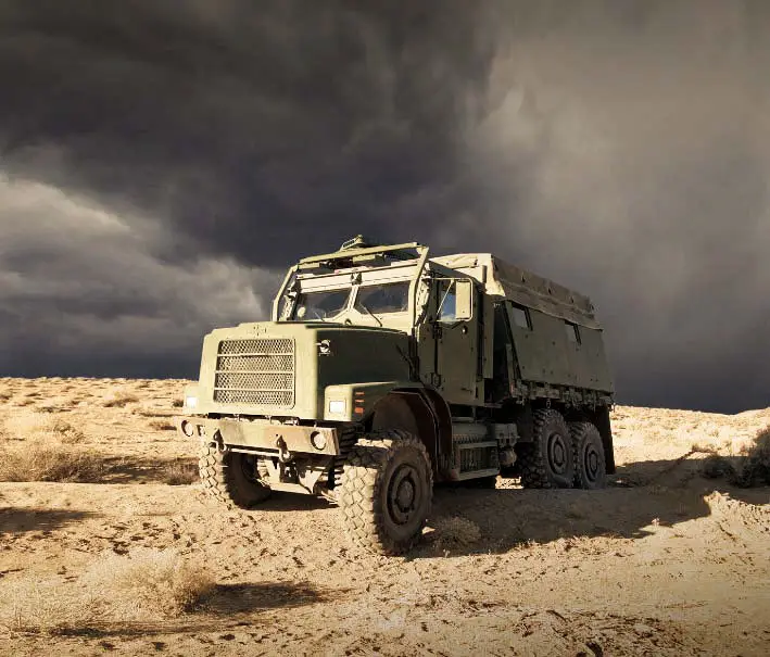 Oshkosh Defense ProPulse tactical wheeled vehicle on a sand covered surface.
