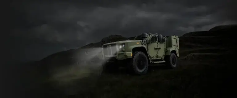 Oshkosh Defense eJLTV on a hillside at night.