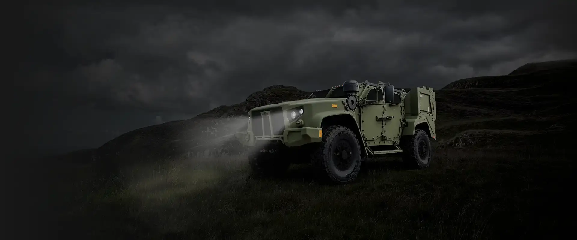Oshkosh Defense eJLTV on a hillside at night.