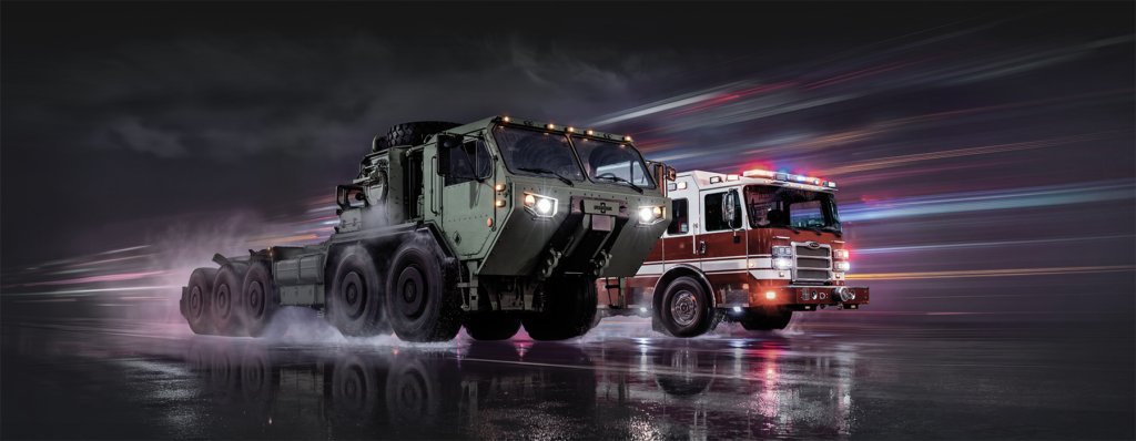 Oshkosh Defense vehicle alongside Pierce firetruck demonstrating corporate advantage